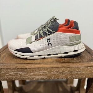 On Running White and Olive Sneakers with Orange Accents